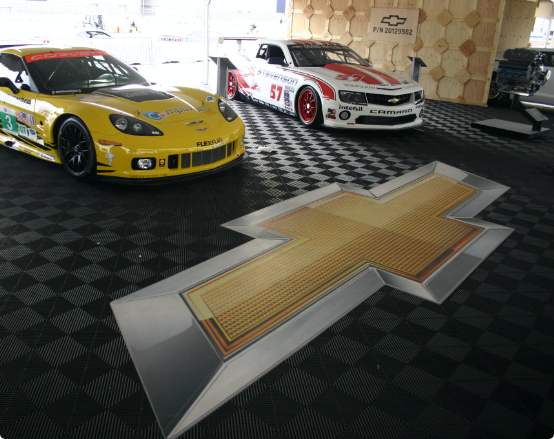 Custom Designed Garage Floor featuring Swisstrax tile and company logo