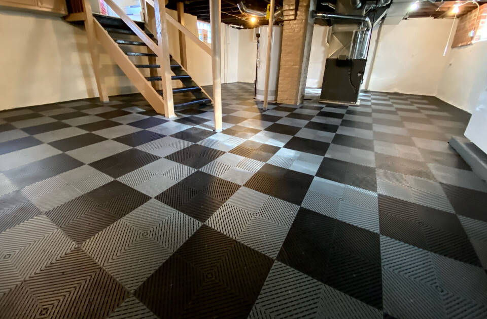 A finished basement with Swisstrax interlocking floor tiles installed
