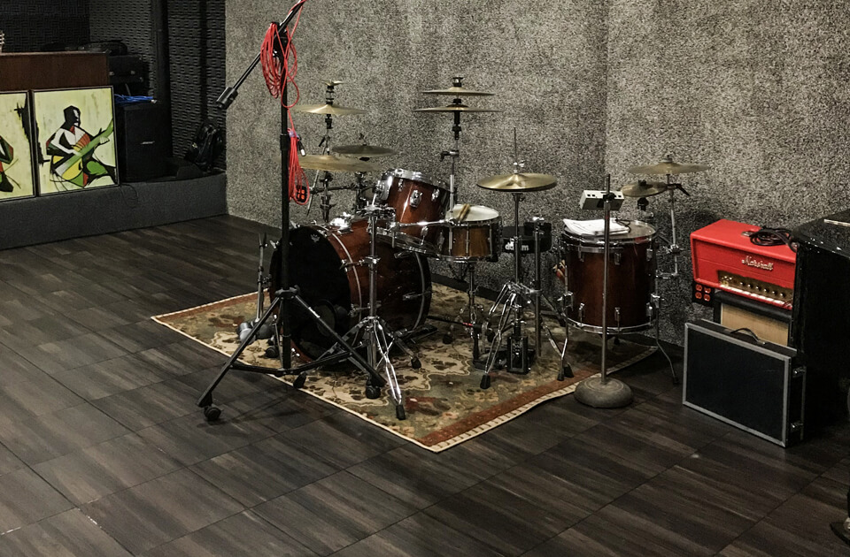 Drumset in a finished basement sitting ontop of Swisstrax flooring tiles