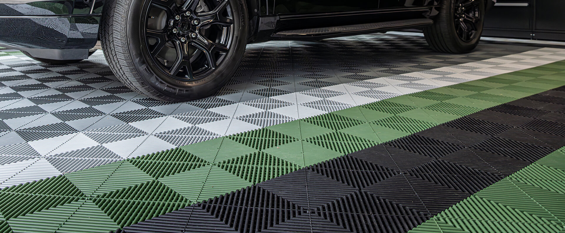 Garage Floor with Green, Gray and Black Tiles.