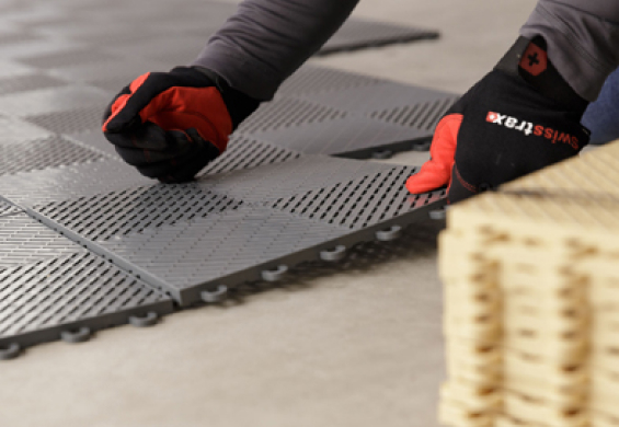 Professional Installer laying down Swisstrax garage flooring