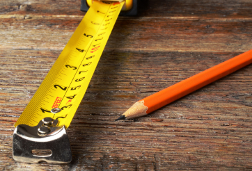 Smiling Man with Headset Looking at Monitor