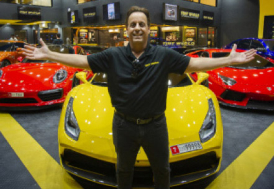 Tint World CEO and president Charles Bonfiglio with arms outspread to show off a huge display room