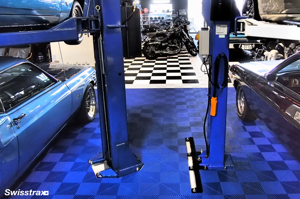 Auto shop car lift ontop of Ribtrax Pro garage floor tiles