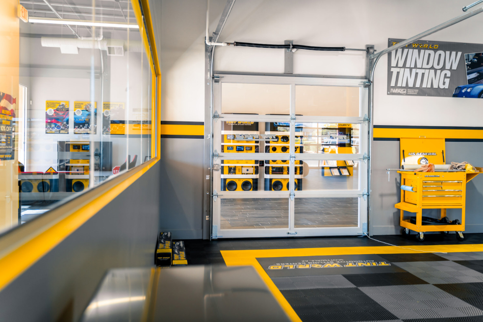 Tint World interior in gray, black and yellow with Ribtrax garage tile flooring