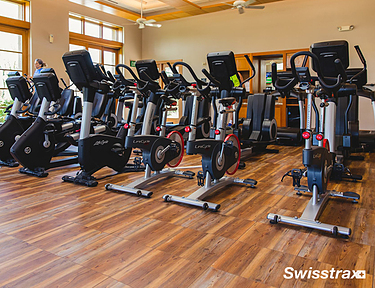 Spinning class gym with Vinyltrax Pro floor tiles with hardwood pattern installed