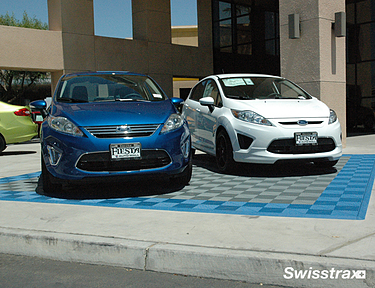 Display cars parked ontop of Swisstrax interlocking floor tiles