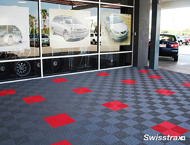 Red and gray Swisstrax floor tiles installed at a dealership