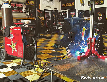 Workshop installed with yellow and black interlocking floor tiles from Swisstrax 