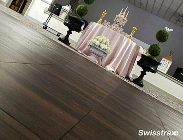 Wedding using Vinyltrax Pro tiles with a dark hardwood pattern