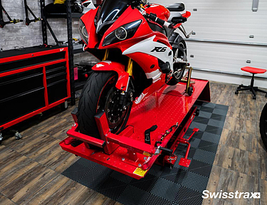 Motorcycle lift on top of a motorcycle pad from Swisstrax