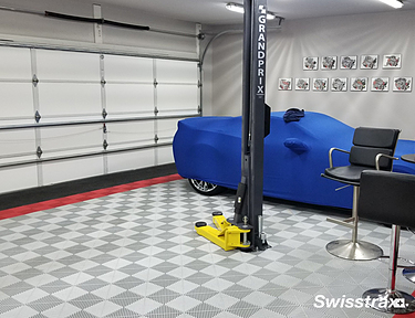 Swisstrax flooring installed in a garage with a vehicle lift
