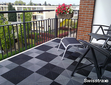 Interlocking floor tiles installed in a balcony garden