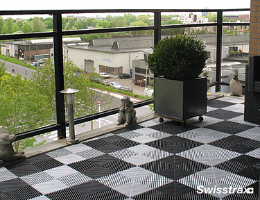 Ribtrax Smooth Pro tiles arranged in a checkerboard pattern on a balcony