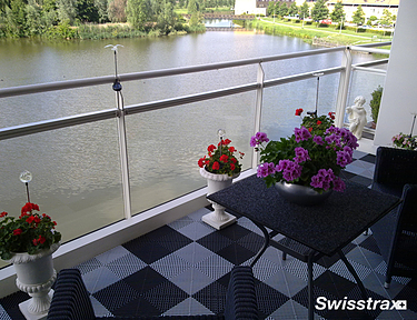 Swisstrax flooring installed on a balcony overseeing a lake