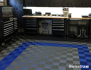 Garage workshop with gray and blue Ribtrax Pro tiles installed